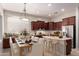 Bright kitchen with dark wood cabinets, stainless steel appliances, and a cozy breakfast nook at 9734 S 182Nd Dr, Goodyear, AZ 85338