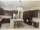 Spacious kitchen features a central island, stainless steel appliances, and stylish dark wood cabinetry at 9734 S 182Nd Dr, Goodyear, AZ 85338