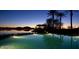Calm lake view at sunset, featuring a swimming pool and distant mountain views at 9734 S 182Nd Dr, Goodyear, AZ 85338