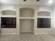 Living room with recessed wall niche, shelving, and wood-look floors; bright and airy space at 9734 S 182Nd Dr, Goodyear, AZ 85338