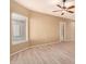 Bright living room features a ceiling fan, light hardwood floors, a window with blinds and a white door at 9734 S 182Nd Dr, Goodyear, AZ 85338