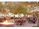 Experience outdoor dining by the fire pit on the patio surrounded by mesquite trees and community members at 9734 S 182Nd Dr, Goodyear, AZ 85338