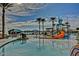 Resort-style pool featuring a water slide and splash pad for endless summer fun at 9734 S 182Nd Dr, Goodyear, AZ 85338