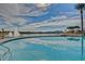 Beautiful pool overlooking a lake with palm trees and a fountain, perfect for relaxation and recreation at 9734 S 182Nd Dr, Goodyear, AZ 85338