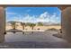 Beautiful pool surrounded by desert landscaping, a block wall, and clear blue skies at 9734 S 182Nd Dr, Goodyear, AZ 85338