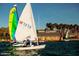 Sailboats out on the water with views of the community clubhouse in the background at 9734 S 182Nd Dr, Goodyear, AZ 85338