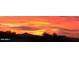 Panoramic sunset view over the desert hills, as orange hues paint the sky with stunning beauty and tranquility at 9734 S 182Nd Dr, Goodyear, AZ 85338