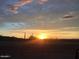Mesmerizing sunset view over the desert landscape, with golden rays illuminating the arid terrain and creating a serene atmosphere at 9734 S 182Nd Dr, Goodyear, AZ 85338