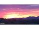 Breathtaking sunset view over the desert mountains, painted with hues of pink and orange, a truly majestic sight at 9734 S 182Nd Dr, Goodyear, AZ 85338