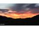 Majestic sunset view over the desert landscape, casting a warm orange and purple glow across the horizon at 9734 S 182Nd Dr, Goodyear, AZ 85338