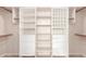 Walk-in closet with built-in shelves, drawers and hanging rods for optimal organization and storage at 9734 S 182Nd Dr, Goodyear, AZ 85338