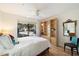 Bedroom with window view, ceiling fan, hard wood floors, and wooden bookcase at 9990 N Scottsdale Rd # 1006, Paradise Valley, AZ 85253
