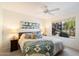 Serene bedroom featuring a king-size bed, ceiling fan, and natural light from the window at 9990 N Scottsdale Rd # 1006, Paradise Valley, AZ 85253