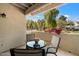 Outdoor covered patio with seating and views of the mature lush landscape at 9990 N Scottsdale Rd # 1006, Paradise Valley, AZ 85253