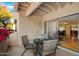 Covered patio with outside seating, decorative plants, and sliding glass doors at 9990 N Scottsdale Rd # 1006, Paradise Valley, AZ 85253