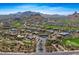 An aerial view of a desert community featuring a golf course, mountain views, and beautiful landscaping at 10798 E Hedgehog Pl, Scottsdale, AZ 85262