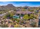 Aerial view of backyard pool and covered patio of this desert property at 10798 E Hedgehog Pl, Scottsdale, AZ 85262