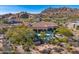 Backyard view with a sparkling pool, covered patio, and manicured landscaping at 10798 E Hedgehog Pl, Scottsdale, AZ 85262