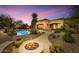 The home's backyard with a pool, fire pit, and outdoor living spaces at 10798 E Hedgehog Pl, Scottsdale, AZ 85262