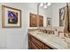 Bathroom vanity with granite countertop and wood cabinetry at 10798 E Hedgehog Pl, Scottsdale, AZ 85262