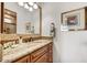 Bathroom boasts travertine countertops, mosaic tile, and a decorative light fixture at 10798 E Hedgehog Pl, Scottsdale, AZ 85262