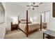 Spacious bedroom with carpet, ceiling fan, and a beautifully carved wooden four poster bed at 10798 E Hedgehog Pl, Scottsdale, AZ 85262