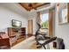 Bedroom with a ceiling fan, an exercise machine, and a hardwood floor at 10798 E Hedgehog Pl, Scottsdale, AZ 85262