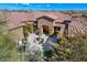 Aerial view showcasing a stone home's courtyard with seating areas and landscaping at 10798 E Hedgehog Pl, Scottsdale, AZ 85262