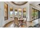 Charming dining area featuring travertine floors and large windows with views of the beautifully landscaped yard at 10798 E Hedgehog Pl, Scottsdale, AZ 85262