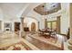 Elegant dining room with decorative ceilings, stone columns, and travertine floors at 10798 E Hedgehog Pl, Scottsdale, AZ 85262