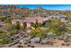 Expansive desert home features a red tile roof, desert landscaping, and mountain views at 10798 E Hedgehog Pl, Scottsdale, AZ 85262