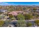 Desert home featuring a red tile roof, mature landscaping, and desert views at 10798 E Hedgehog Pl, Scottsdale, AZ 85262