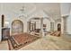 Welcoming foyer with stone columns, arched doorways, and travertine flooring at 10798 E Hedgehog Pl, Scottsdale, AZ 85262