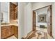 Hallway features a wet bar, tile flooring, and a decorative rug at 10798 E Hedgehog Pl, Scottsdale, AZ 85262