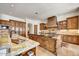 Spacious kitchen featuring custom wood cabinetry, granite countertops, and center island at 10798 E Hedgehog Pl, Scottsdale, AZ 85262