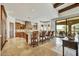 Gourmet kitchen with island seating, stone countertops, and travertine floors at 10798 E Hedgehog Pl, Scottsdale, AZ 85262