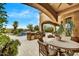 Wonderful outdoor kitchen with stainless steel grill and seating area overlooking the pool at 10798 E Hedgehog Pl, Scottsdale, AZ 85262