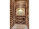 Custom wine cellar featuring wooden racking, lighting, and space for glassware at 10798 E Hedgehog Pl, Scottsdale, AZ 85262