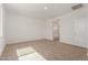 Bright bedroom with neutral carpet and white walls offering a glimpse into the attached bathroom at 1187 E Ridgerock St, Casa Grande, AZ 85122