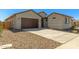 Inviting single-level home with a two-car garage, desert landscaping, and a tile roof at 1187 E Ridgerock St, Casa Grande, AZ 85122