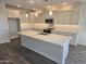 Modern kitchen featuring white cabinets, granite countertops, and a large kitchen island at 1187 E Ridgerock St, Casa Grande, AZ 85122