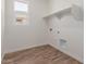 Laundry room features tile flooring, shelving, and window for natural light at 1187 E Ridgerock St, Casa Grande, AZ 85122