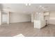 Bright and airy living room and open kitchen featuring modern finishes and wood-look tile flooring at 1187 E Ridgerock St, Casa Grande, AZ 85122