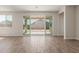 Spacious living room area with wood-look floors and a sliding glass door to the yard at 1187 E Ridgerock St, Casa Grande, AZ 85122