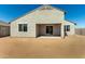 A view of a home's neutral-colored exterior, covered patio, and desert landscaping at 1191 E Ridgerock St, Casa Grande, AZ 85122