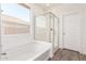 Bright bathroom showcasing a bathtub, glass enclosed shower, and window that provides plenty of natural light at 1191 E Ridgerock St, Casa Grande, AZ 85122