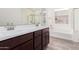 Bathroom showcasing a double sink vanity with dark wood cabinets, with a separate tub and shower with tile flooring at 1191 E Ridgerock St, Casa Grande, AZ 85122