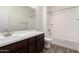 Bathroom showcasing a single sink vanity with dark wood cabinets, with a tub and shower combo with tile flooring at 1191 E Ridgerock St, Casa Grande, AZ 85122