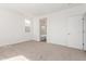 This room features neutral carpet, white walls, and an open doorway to the bathroom, plus one bright window at 1191 E Ridgerock St, Casa Grande, AZ 85122