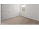 This carpeted bedroom features a window for natural light, plus two doors for closet access and a door to the room at 1191 E Ridgerock St, Casa Grande, AZ 85122